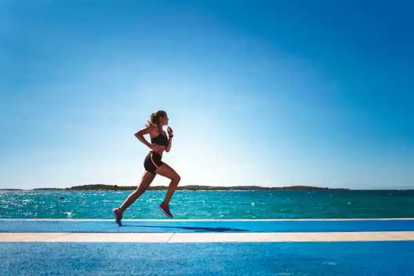 Woman running showing strong leg muscle Chorley